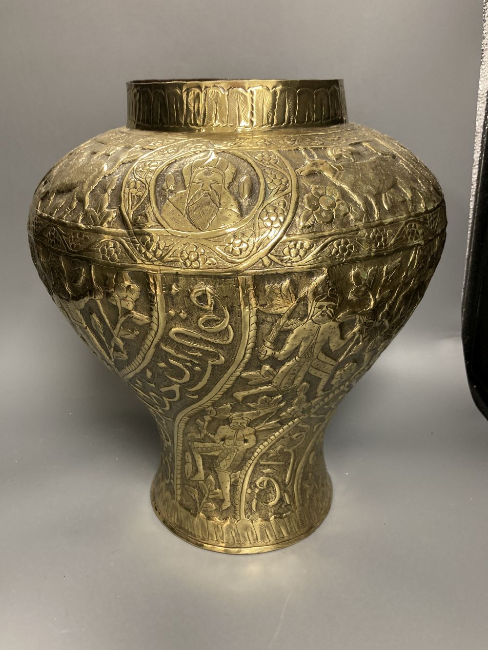 A Persian brass vase, height 38cm, and a bottle stand